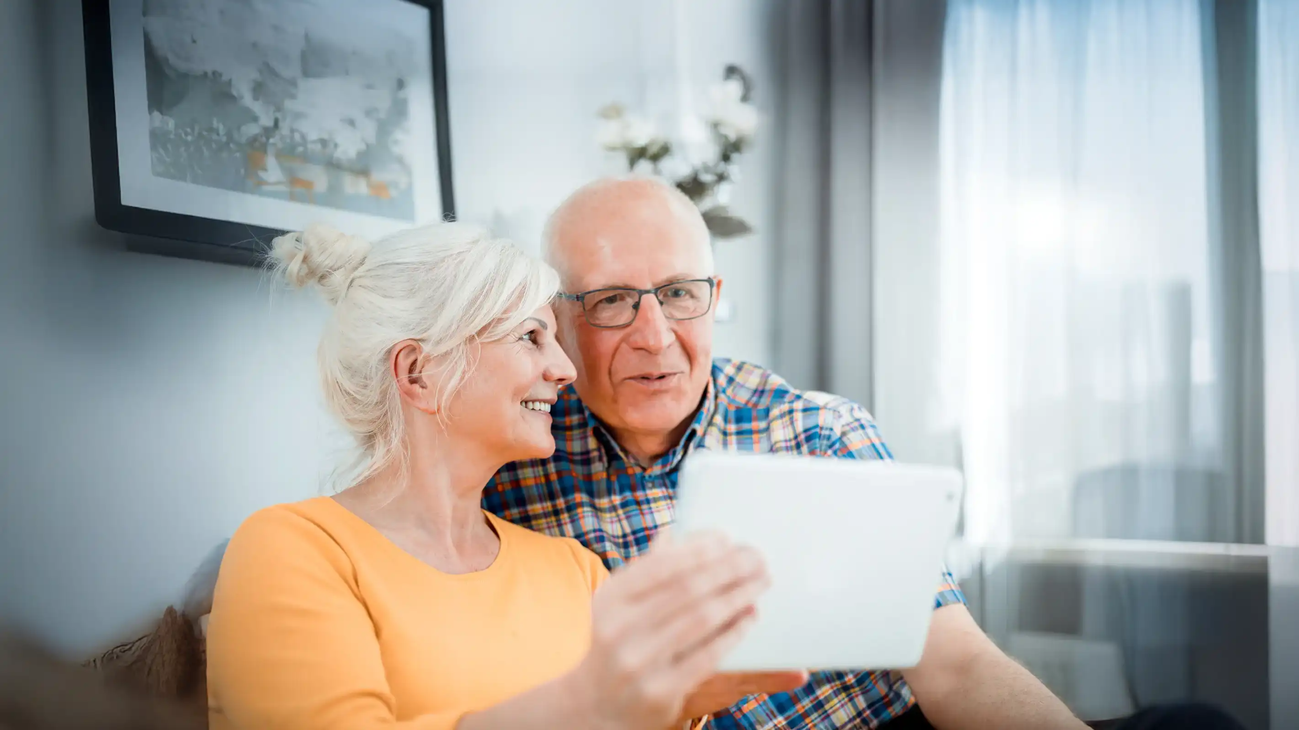 Senior couple looking at a tablet