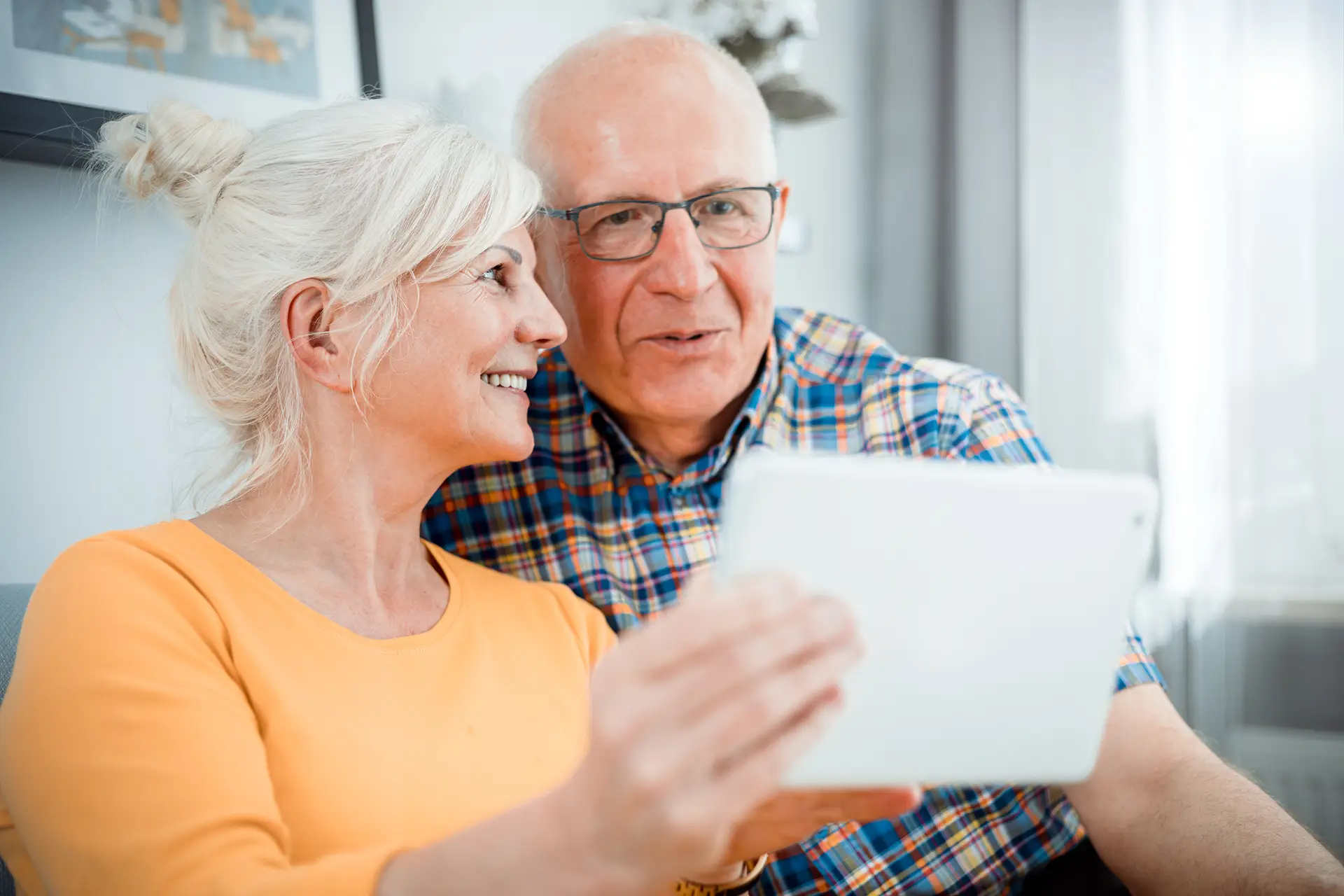 Senior couple looking at a tablet